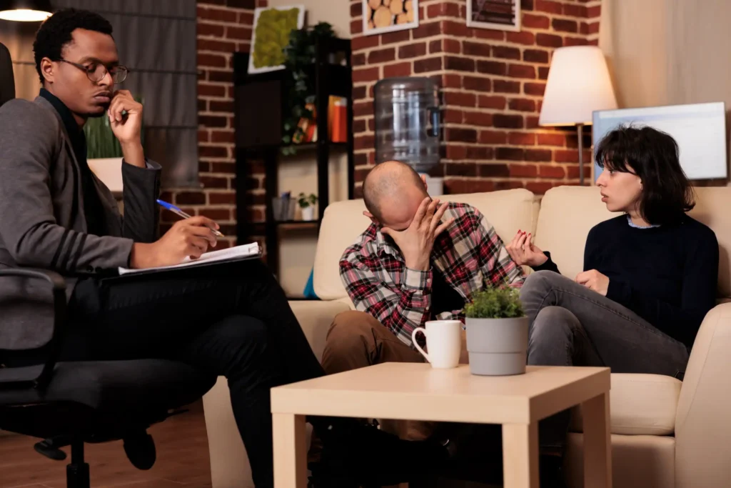 Couple therapy session: distressed man and counselor