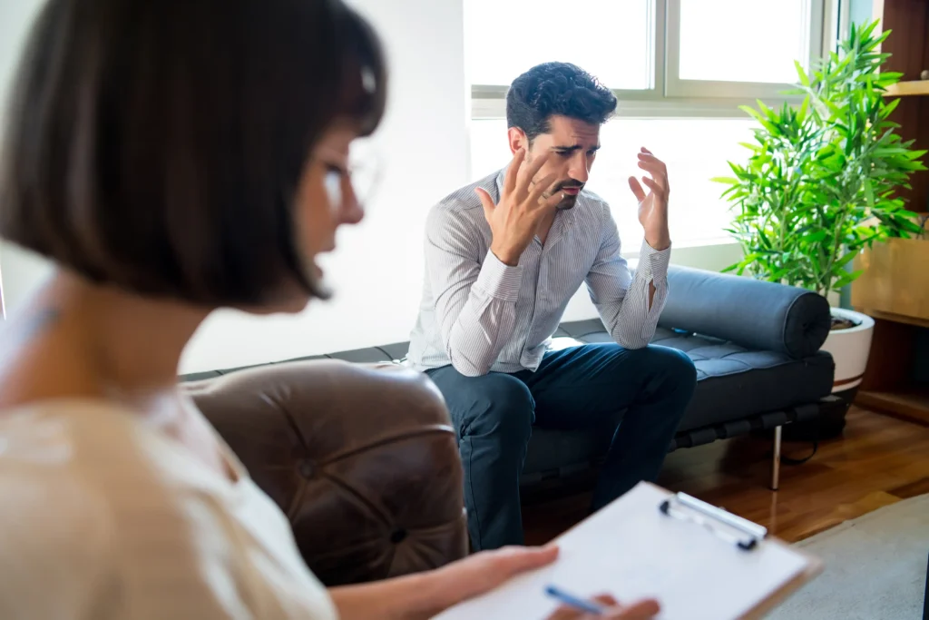 Man expressing distress during therapy session