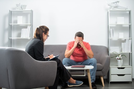 Man holding head during therapy session